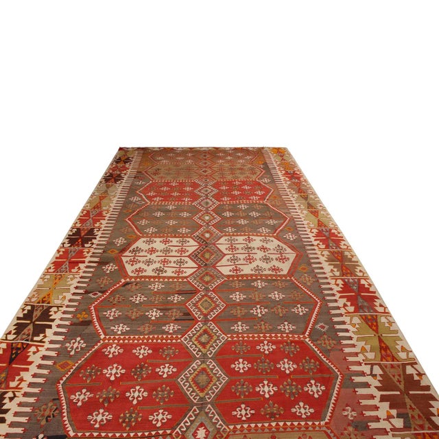 Flat-woven in high-quality wool originating from Turkey between 1930-1940, this vintage Konya Kilim rug enjoys a...