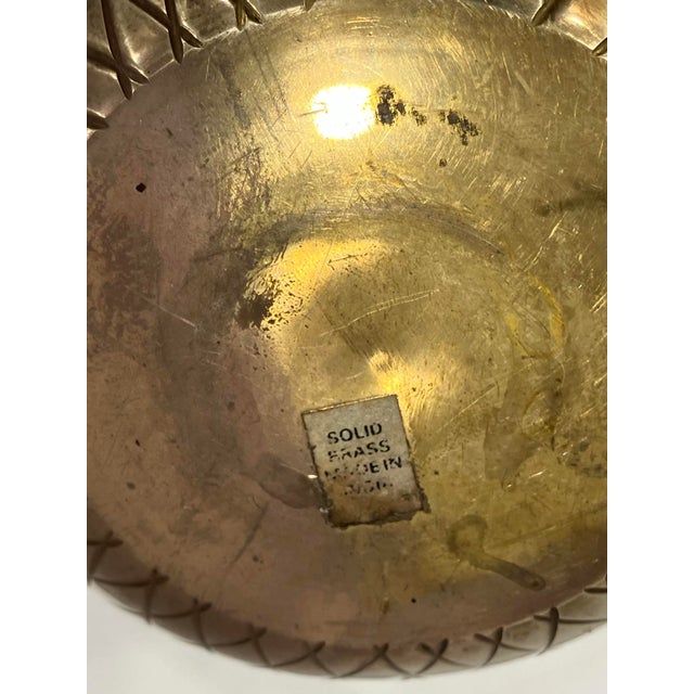 This pineapple box is made of solid brass. The incised lines represent the outer sections of a pineapple. Fine metal work