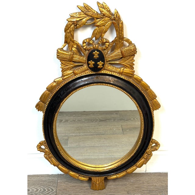Carvers' Guild Louis XVI Style Giltwood & Ebonized Oval Wall Mirror, Circa 1965. This elegant early Carvers' Guild mirror...