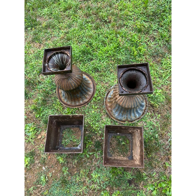 Late 20th century pair of campana form garden urns on appropriate bases with exceptional weathered patina. Once gracing...