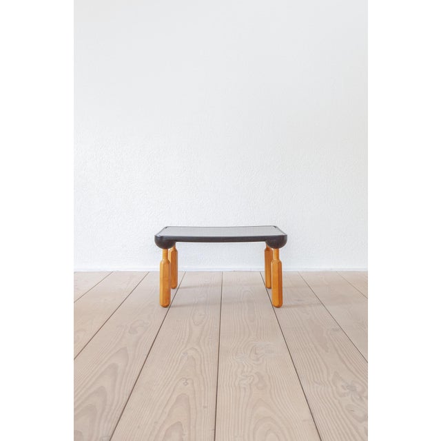 The “Cacciavite” coffee table / side table, featuring a plastic top and beech wood legs, was designed by Achille & Pier...