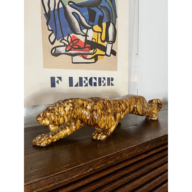 Striking vintage ceramic leopard sculpture with a rich, high-gloss glaze in warm caramel and espresso tones. The...