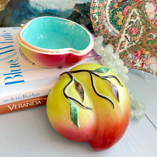 A large peach form lidded box used as altar or temple fruit. Porcelain fruit design with applied stem and leaves. Outer...