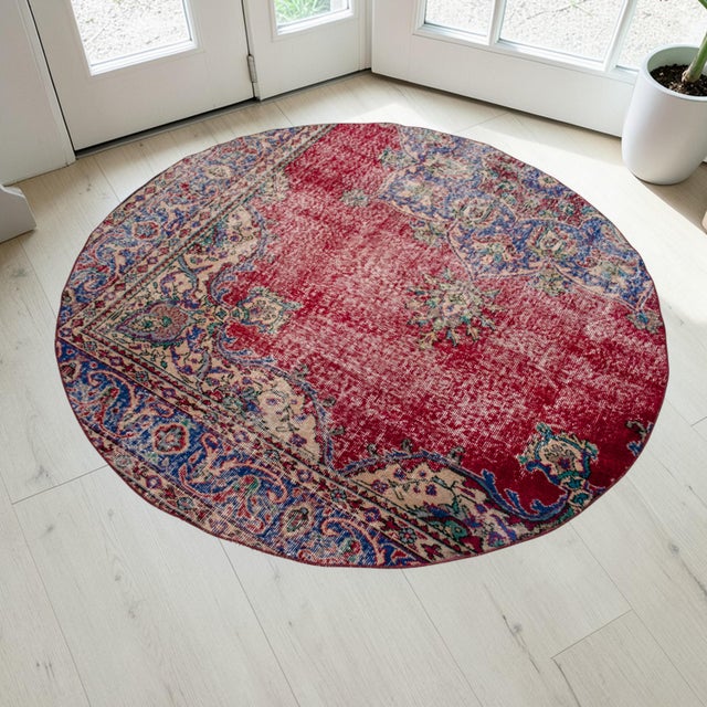 This gracefully repurposed circular rug breathes new life into a classic vintage hand-knotted Konya carpet, thoughtfully...