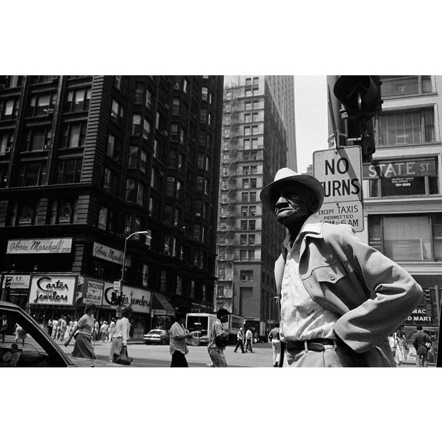 African American Man on Street Corner is a Black and White Print of Hahnumuhle paper available in this size of 8" x 10" in...