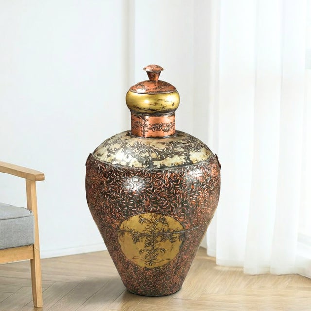 Dimensions: 22" W x 22" D x 40" H This is a vintage, hand embossed metal barrel from India. Used to store grains back in...