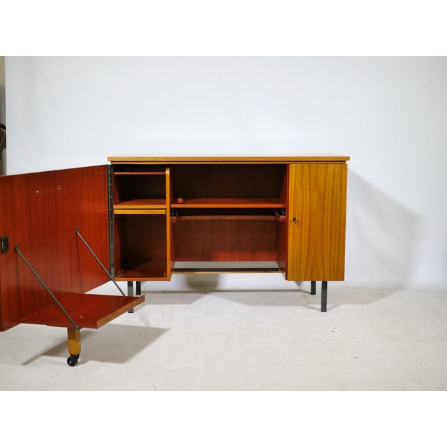 Compact teak sideboard/folding desk combination with clean lines and a functional design. An integrated, extendable work...