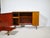 Compact teak sideboard/folding desk combination with clean lines and a functional design. An integrated, extendable work...