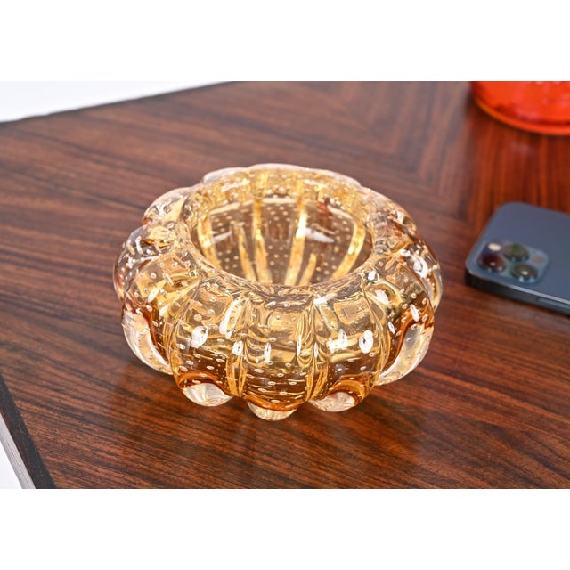 Delightful round bowl or ashtray made in a stunning multicolor amber Murano glass using the "bullicante" technique. This...