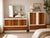 A striking matching vintage Mid-Century Modern dresser set consisting of an 8-drawer lowboy and coordinating 4-drawer...