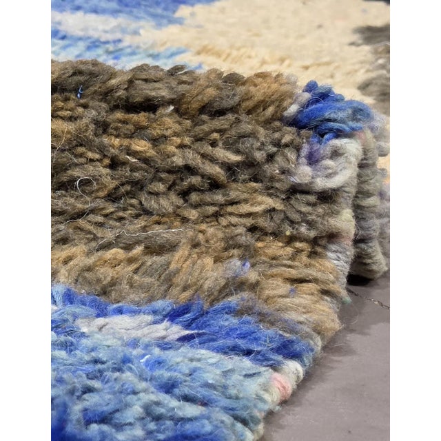 Contemporary Moroccan Rug | Handwoven Berber Wool Rug with Blue Field and Abstract Landscape Motifs This painterly...