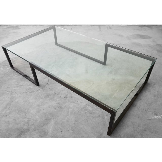 This is an extremely large and versatile metal and glass coffee table. The table frame is a unique shape and very minimal...