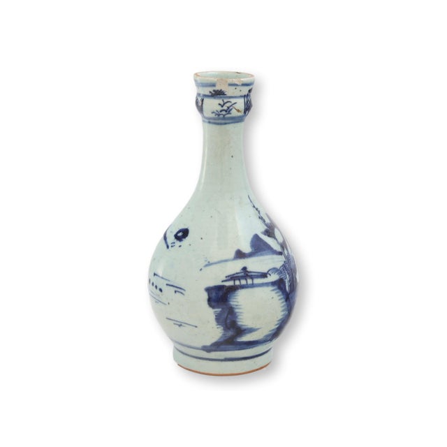 19th century Chinese export porcelain bottle featuring hand-painted blue and white decoration on a classic baluster-form...