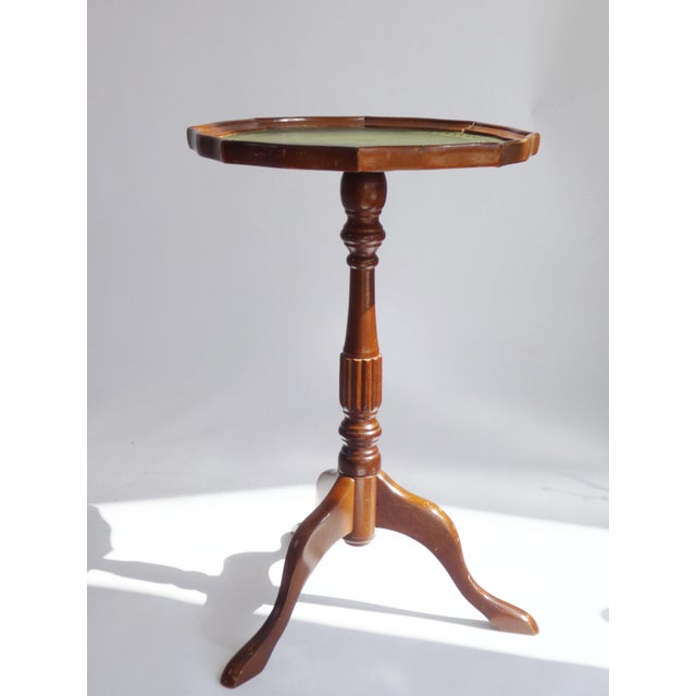 Victorian style English wooden table with a green leather top with golden details. Very useful to place at any space in...