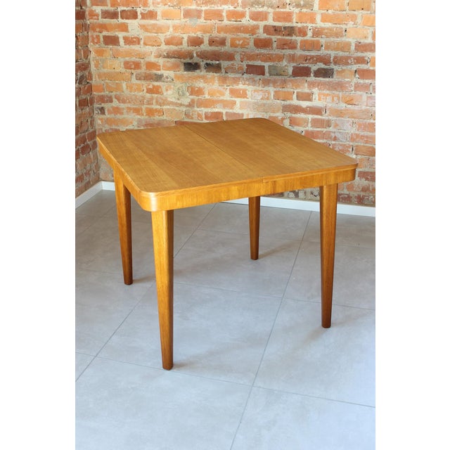 A compact and highly functional extendable dining table produced in 1968 by Jitona, Soběslav - one of Czechoslovakia's...