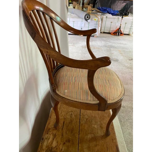 Not sure, but I am thinking French. Walnut, bentwood, curved arm chair with rounded, upholstered seat. Cabriole legs. One...