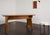 A sculptural Italian desk from the 1950s, crafted in walnut veneer with a light, warm patina, featuring tapered legs and...