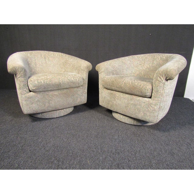 Pair of stylish Mid-Century Modern armchairs that are upholstered in an attractive beige fabric and cushioned for...