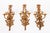 A set of six antique Louis revival ormolu three branch wall lights, circa 1920 in date. They each feature three spiral-...