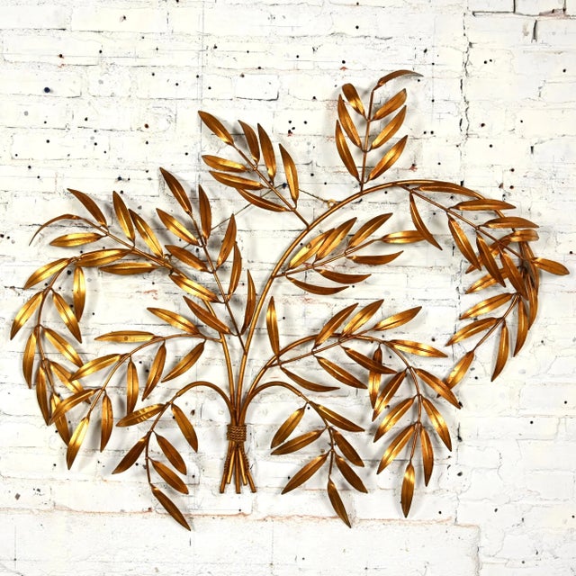 Incredible vintage Italian Mid Century Hollywood Regency gilt metal wall sculpture of branches with leaves. Beautiful...