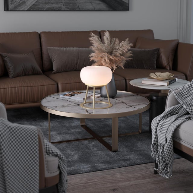 TRIPOD - where sculptural design meets luminous artistry. This statement piece features a striking white oval-shaped glass...