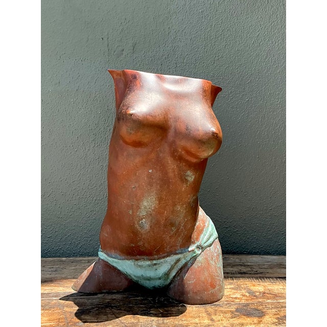 This vintage figurative bronze sculpture presents a graceful interpretation of the female torso, capturing both strength...