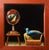This artwork features a striking still life composition, showcasing a vibrant blue bird perched on a chair beside an...
