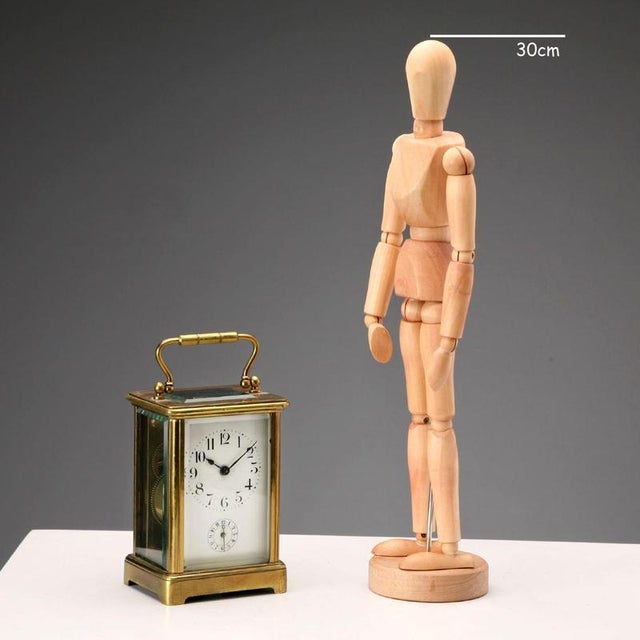 Travel clock in bronze and beveled glass. Cylinder escapement movement and visible mechanism. Enamelled metal dial with...