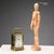 Travel clock in bronze and beveled glass. Cylinder escapement movement and visible mechanism. Enamelled metal dial with...