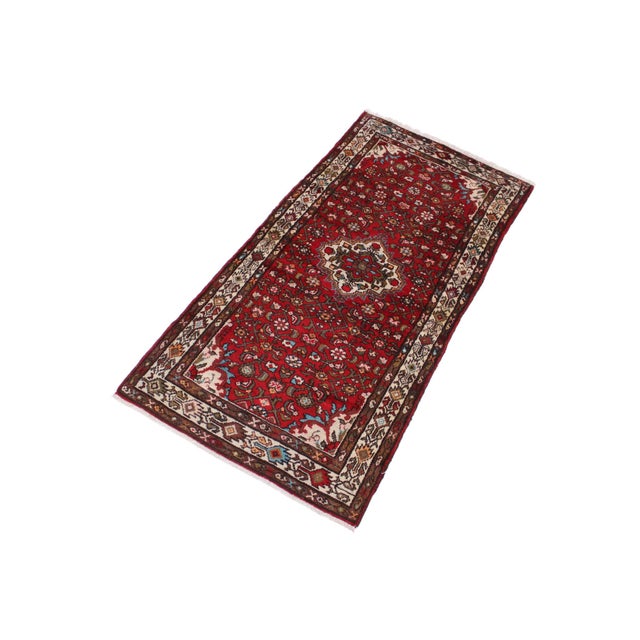 Add timeless character and warmth to your space with this beautiful hand-knotted wool rug measuring approximately 3.5 x 7...