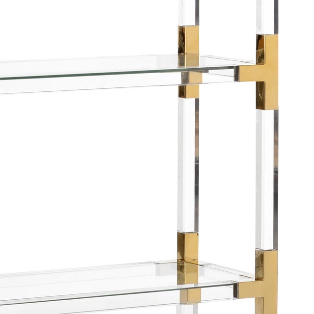 Five shelf acrylic etagere with gold metal supports and tempered glass shelves.