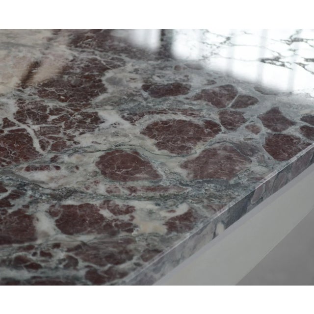 This decorative coffee table is handcrafted using a Tuscany marble, known as Paonazzo. This selected marble has suggestive...