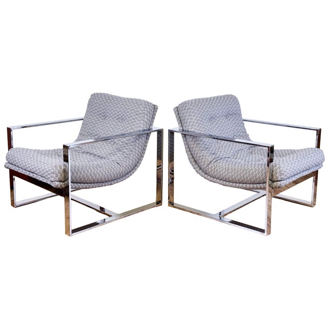 Stunning pair of vintage MCM chrome framed lounge chairs in the style of Milo Baughman, circa 1970s. Chairs feature a...