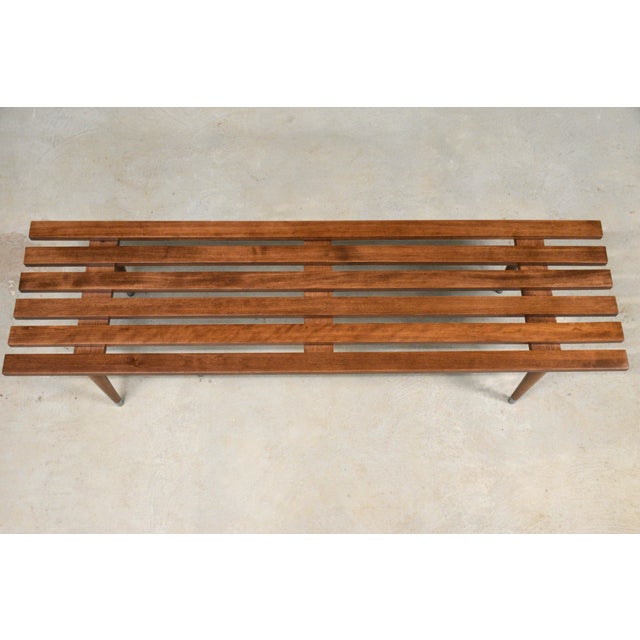 A mid century modern walnut color solid beech coffee table or entryway bench. Professionally refinished. Made in USA....