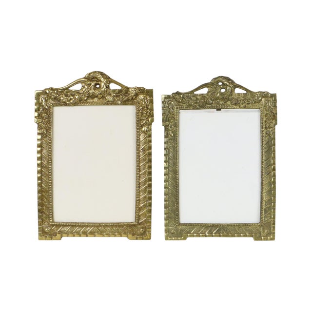 A pair of antique French photo frames in the style of JH France, crafted from polished brass; dating from the first half...