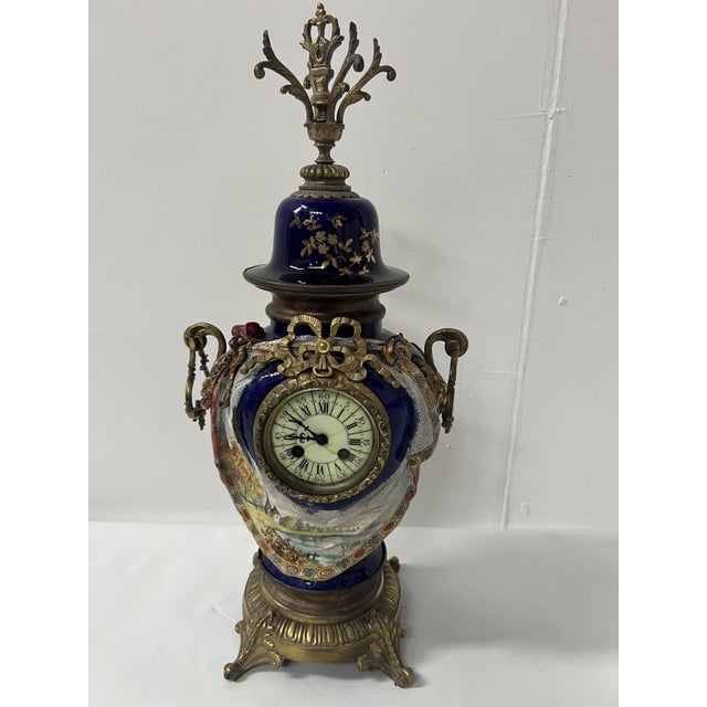 Earthenware and bronze mantelpiece set clock with landscape decoration and bronze base two candlesticks with landscape...