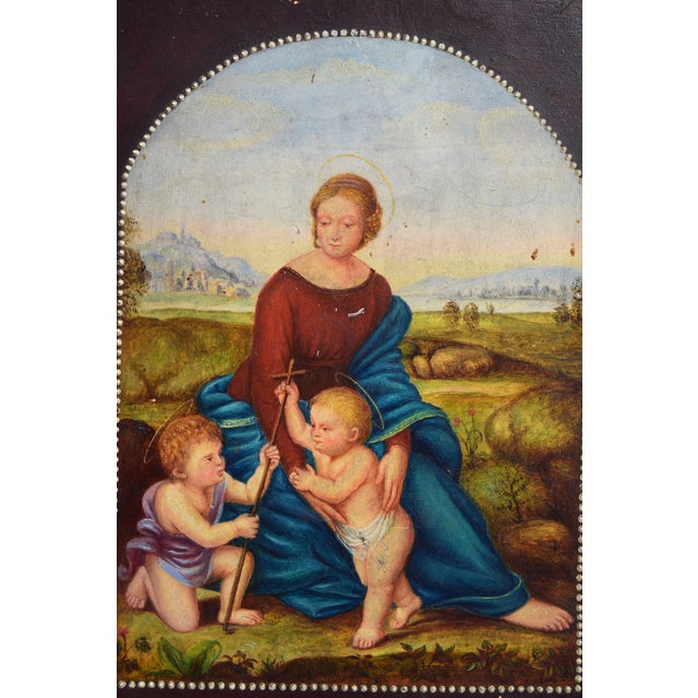 Antique oil on wood panel, likely Italian, depicting the Madonna and Child with the infant Saint John the Baptist, based...