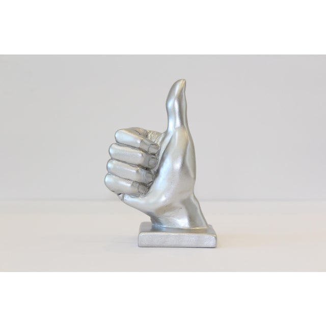 As an eye catching accent, this “Thumbs Up” hand symbol sculpture is sure to bring an uplifting and stylish vibe to any...