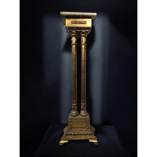 This elegant 1950s pedestal is designed in a Romanesque style, featuring classic columns crafted from gilded wood. The...