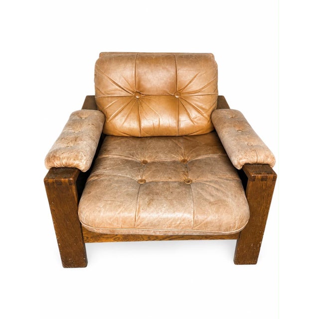 A substantial pair of characterful armchairs in the brutalist style by asko, featuring a solid oak frame and original,...
