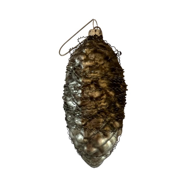 An antique, German, wire-wrapped (over heavy silvered glass?) Christmas ornament in the shape of a pinecone. 4.5"x2".