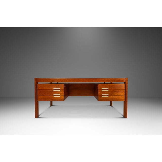 This iconic Danish modern "floating" executive desk, produced by the lauded Dyrulud in the late 60's - early 70's,...