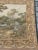 Exquisite French tapestry featuring a charming scene of a fountain in nature among the trees which are surrounded by...