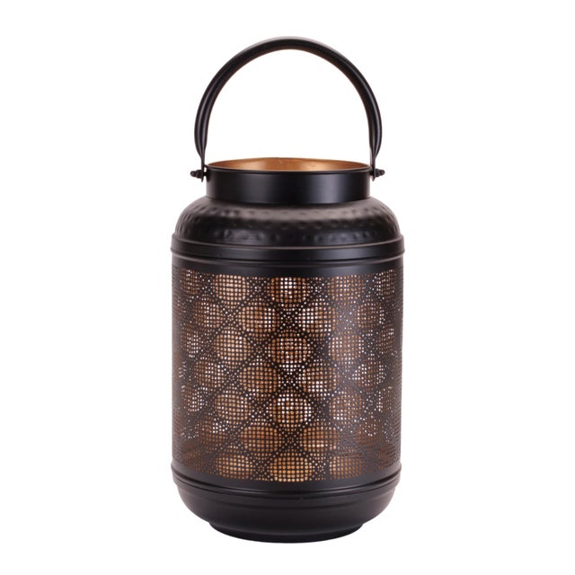 Create a warm, inviting glow with this Decorative Perforated Iron Lantern. Crafted from durable iron with an intricate...