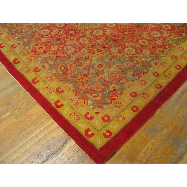 The field abrashes from coral to red and supports an all-over Herati pattern exactly matched in scale by that of the...