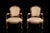 A refined pair of French Louis XV style fauteuil armchairs crafted in carved and gilt wood during the 19th century. The...