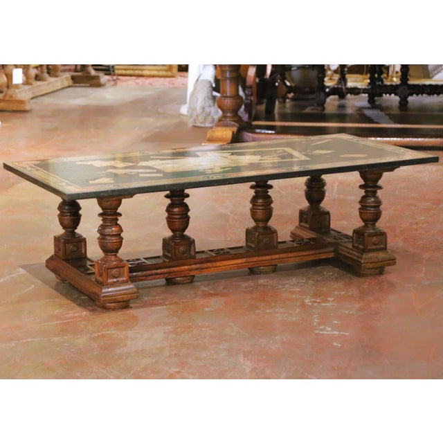 Bring a sophisticated Old World accent to a seating area or library with this elegant antique coffee table crafted in...