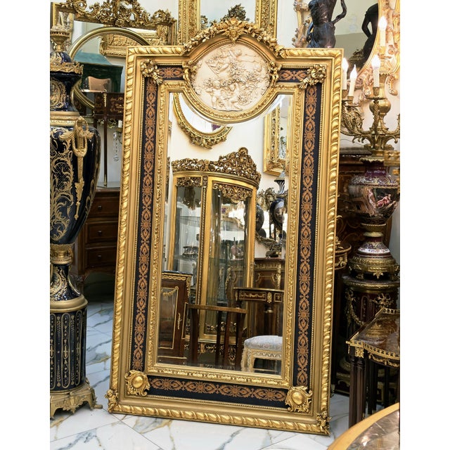 Make a dramatic statement with this grand French-inspired wall mirror, featuring an exquisite sculpted frame finished in...