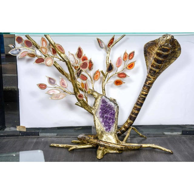 This console table with amethysts and agates takes the form of a snake around a tree. This piece has an attribution mark,...