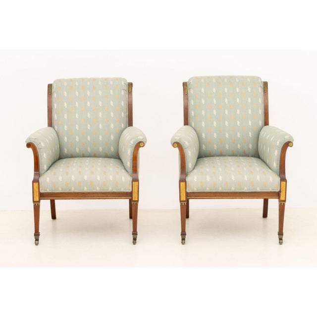 Pair of Swedish Mahogany Bergeres, 19th century, with light blue upholstery with feather motif, gilt metal accents and...